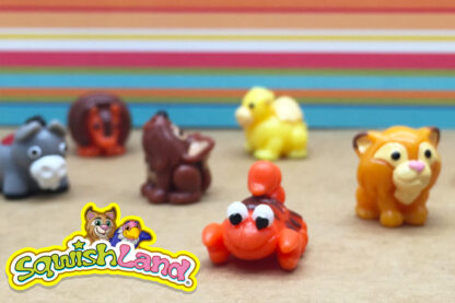 A group of plastic animals sitting on top of a table.
