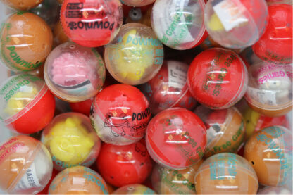 A pile of assorted colored balls with different designs.