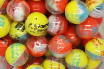A pile of different colored balls with designs on them.