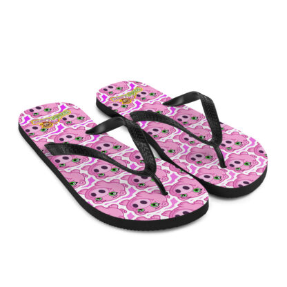 A pair of flip flops with pink and white skulls on them.