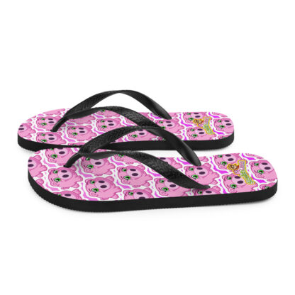 A pair of flip flops with a pink background and black straps.