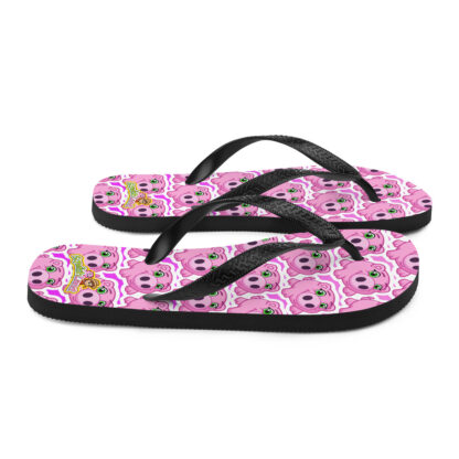 A pair of flip flops with pink and black designs.