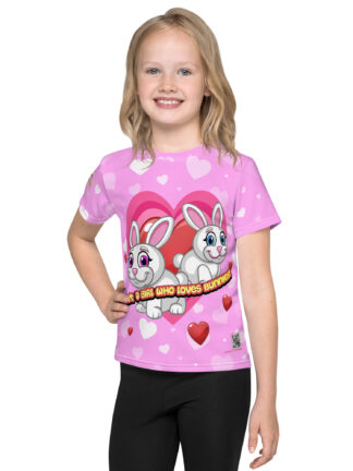 A girl wearing black pants and pink shirt with hearts.