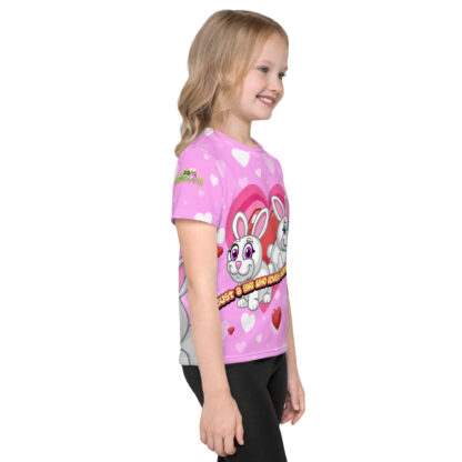 A girl wearing a pink shirt with hearts and animals.