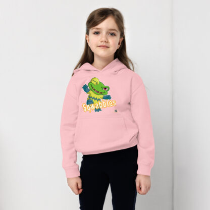 A girl wearing a pink hoodie with a frog on it.