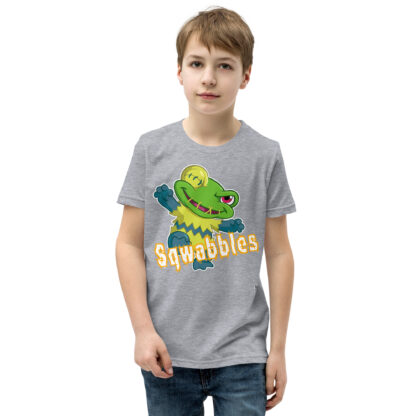 A kid wearing a t-shirt with the word squabbles on it.
