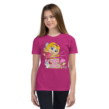 A girl wearing a pink shirt with a cartoon of a blond girl.