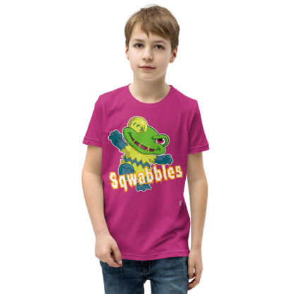 A kid wearing a pink t-shirt with squabbles on it.