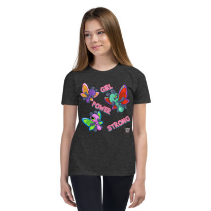 A girl wearing black jeans and a t-shirt with colorful butterflies.