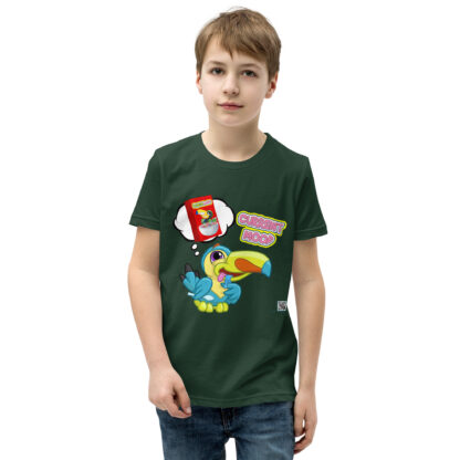 A boy wearing a green shirt with cartoon images on it.