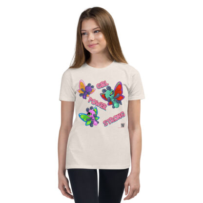 A girl wearing white jeans and a t-shirt with colorful butterflies.