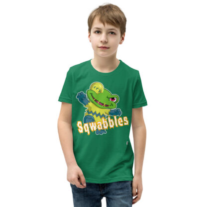 A kid wearing a green shirt with squabbles on it.
