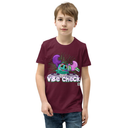A kid wearing a t-shirt with the words " vibe chuck ".