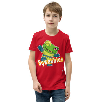 A kid wearing a red t-shirt with the word squabbles on it.