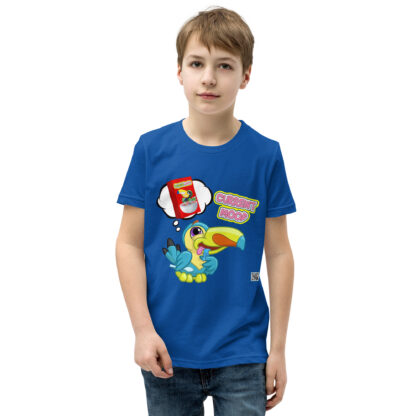 A boy wearing a blue t-shirt with stickers on it.